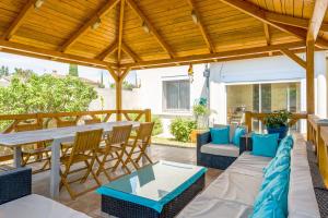an outdoor patio with a table and chairs at Studio piscine Alpilles in Noves