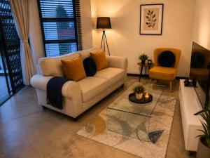 a living room with a couch and a table at Staynrestapartment in Nelspruit