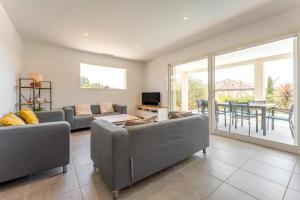 a living room with two couches and a table at Villa Hestia in Goudargues