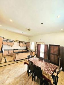 a large room with a wooden table and chairs at Royal Villa in Karachi +16 photos