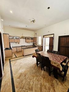 a large room with a table and chairs in it at Royal Villa in Karachi