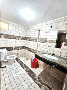 a bathroom with a toilet and a sink at Royal Villa in Karachi