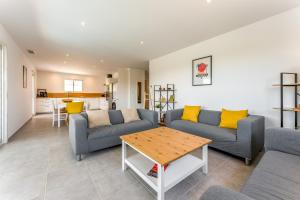 a living room with two couches and a table at Villa Hestia in Goudargues