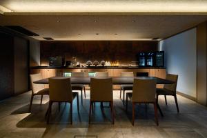 a dining room with a table and some chairs at Gion Kuromatsu in Kyoto