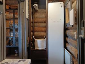a refrigerator in a pantry with a basket in it at Ruska in Syöte +14 photos