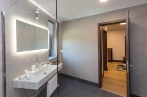 a bathroom with a white sink and a mirror at Complex Gallery Vitosha **** in Sofia +37 photos