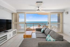 a living room with a couch and a view of the ocean at Villa Seascapes in Coolum Beach