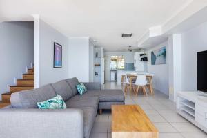 a living room with a couch and a table at Villa Seascapes in Coolum Beach