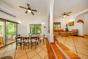 a dining room and living room with a table and chairs at Riviera Maya Suites in Playa del Carmen