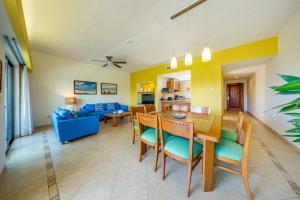 a dining room and living room with a table and chairs at Riviera Maya Suites in Playa del Carmen +291 photos