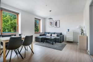 a living room with a couch and a table at Modernized Bed & Bath in Holstebro +30 photos