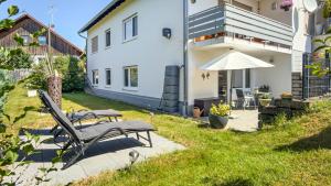 a patio with two benches and an umbrella at Carmen in Wald