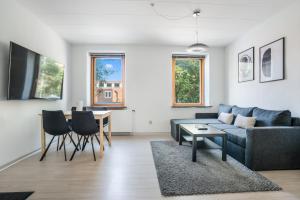 a living room with a couch and a table at Modernized Bed & Bath in Holstebro
