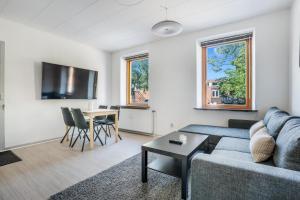a living room with a couch and a table at Modernized Bed & Bath in Holstebro