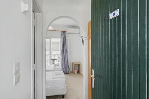 a room with a green door and two beds at The Kavos Sandy Inn in Kavos +71 photos