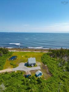 an aerial view of a house and the ocean at Ocean Pines seaside cottage in Shelburne