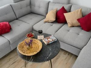 a living room with a couch and a glass table at FEWOHOME Lothe Schieder Schwalenberg Schiedersee in Schieder-Schwalenberg