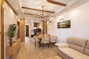 a living room with a couch and a dining room table at Villa President 3 in Krimovice
