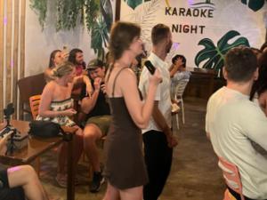 a woman standing in front of a crowd of people at Chill Out Hostel in Boracay