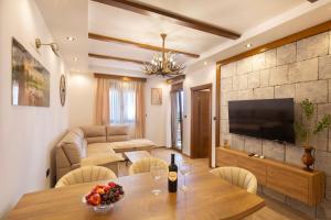 a living room with a table and a couch at Villa President 3 in Krimovice