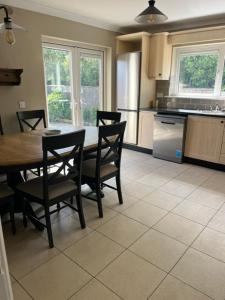 a kitchen with a table and chairs in a kitchen at Sruthan na Teorainn in Carraroe