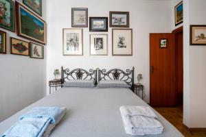 a bedroom with a large bed with pictures on the wall at B&B A Casa Di Gina in Polignano a Mare +35 photos