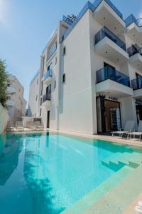 a swimming pool in front of a building at Zurich Hotel in Ksamil