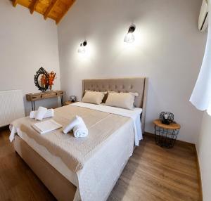 a bedroom with two beds with towels on them at Granny's Home in Roussopoúlion