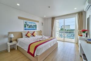 a bedroom with a large bed and a balcony at Summer Dream Hotel in Phú Quốc +57 photos