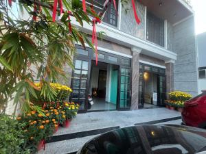 a building with a bunch of flowers in front of it at Happy Sun Hotel in Mỹ Tho