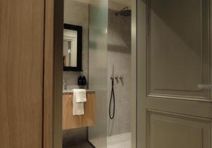 a bathroom with a shower and a sink at Ausma Hotel in Kuldīga +53 photos