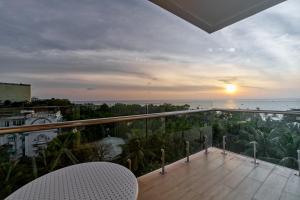 a balcony with a view of the ocean at sunset at Summer Dream Hotel in Phú Quốc