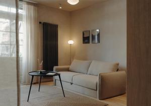 a living room with a couch and a table at Ausma Hotel in Kuldīga