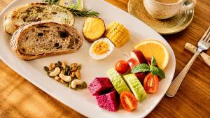 a plate of breakfast food with eggs fruit and vegetables at Family Pottery in Hengchun South Gate