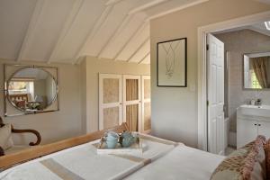 a bedroom with a bed with a mirror and a sink at North Lodge at Pudleston Court in Hatfield +13 photos