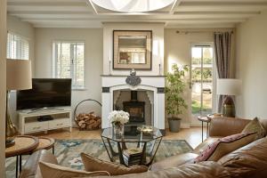a living room with a couch and a fireplace at North Lodge at Pudleston Court in Hatfield