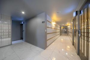a hallway in a building with a hallway at Gimhae Tour Hotel in Gimhae