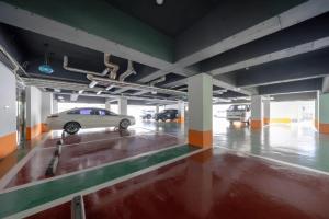 a parking garage with a car parked in it at Gimhae Tour Hotel in Gimhae