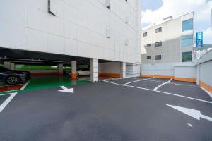 a parking lot with a car parked in a building at Gimhae Tour Hotel in Gimhae +8 photos