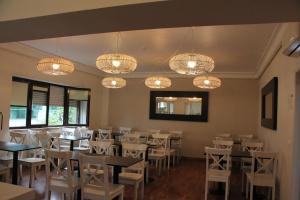 a dining room with tables and chairs and chandeliers at Imperador Hotel in Lisbon