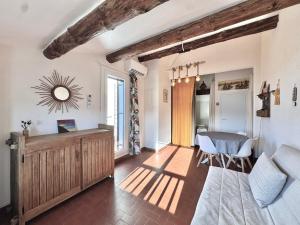 a living room with a table and a dining room at L'étincelle de Camargue, Plage et centre à pied in Saintes-Maries-de-la-Mer