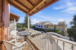 a balcony with a table and chairs and a view at Mermaids By The Sea in Mesongi