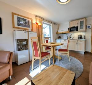 a kitchen with a table and chairs in a room at Ferienwohnung Jodlschmid in Ruhpolding