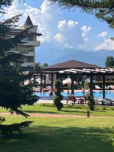 a resort with a swimming pool and a building at Hotel Sevtopolis Medical & SPA in Pavel Banya