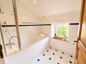 a bathroom with a tub and a sink at La spacieuse maison des miots in Saint-Simeux