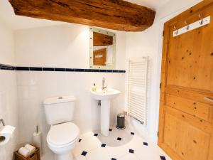 a bathroom with a toilet and a sink at La spacieuse maison des miots in Saint-Simeux +21 photos