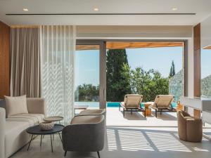 a living room with a couch and chairs at Doci Kelios - Serenity Suites with Private Heated Pools, by ZanteWize in Agios Nikolaos