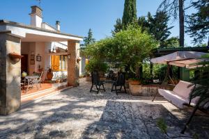 a patio of a house with a table and chairs at B&B A Casa Di Gina in Polignano a Mare