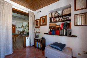 a living room with a couch and a book shelf at B&B A Casa Di Gina in Polignano a Mare