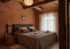 a bedroom with a bed with two towels on it at Ausma Hotel in Kuldīga